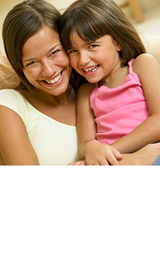 Smiling woman and girl pose together