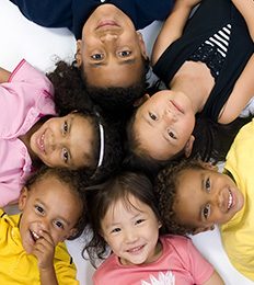 Group of smiling students forming a circle with their heads