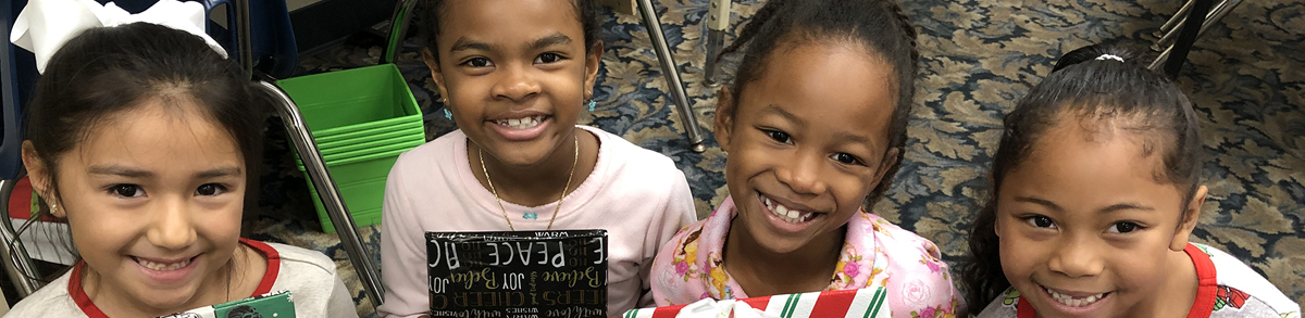 Four smiling female Oakwood Academy students